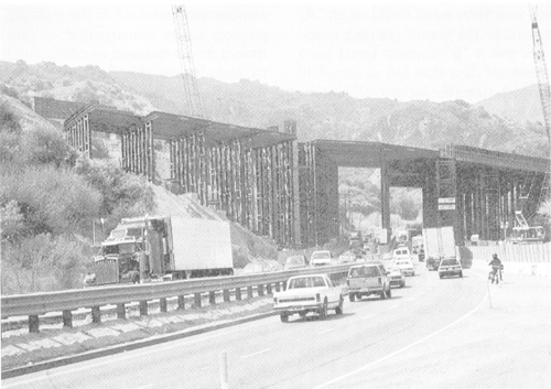 Caltrans was faced with not only the problem of restoring the freeway system, but of accommodating and detouring an enormous traffic flow. Shown here is the Old Road detour below the Gavin Canyon Bridge