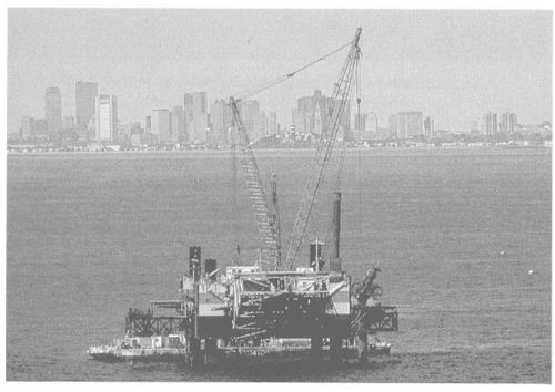 A 3,100-ton diffuser barge placed 55 riser pipes that will connect to the last 1.25 miles of the 9.5-mile effluent outfall tunnel. The pipes will disperse treated wastewater from the new plant into Massachusetts Bay