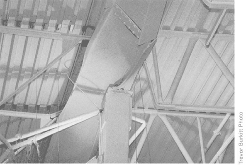 The w24x76 beam supporting a portion of the roof, fails over the column