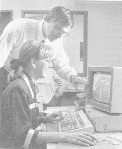 Student Danna Guffey, contract administrator at Fairbanks Morse Pumps, develops proficiency with PM software under the direction of instructor Lavon Winkler, general manager of the DuPont Group at Butler Manufacturing
