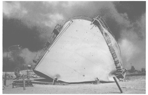 Retreating Iraqi farces destroyed as much Kuwaiti petroleum production and storage facilities as possible. This destroyed crude oil tank was typical of the repair jab facing this project team