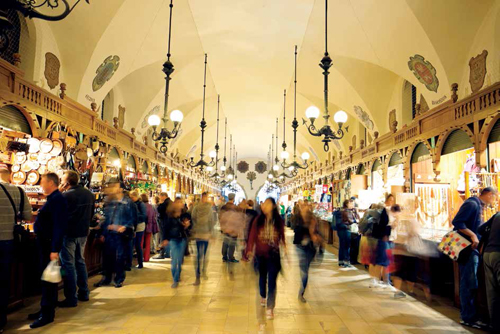 Tourists in Sukiennice Cloth Hall in Krakow, Poland, a major shopping destination